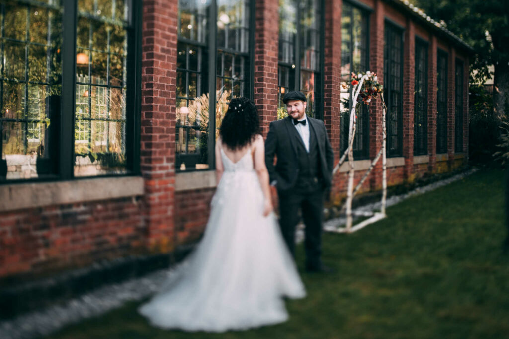 A bride and groom enjoy their first look at The Lace Factory.