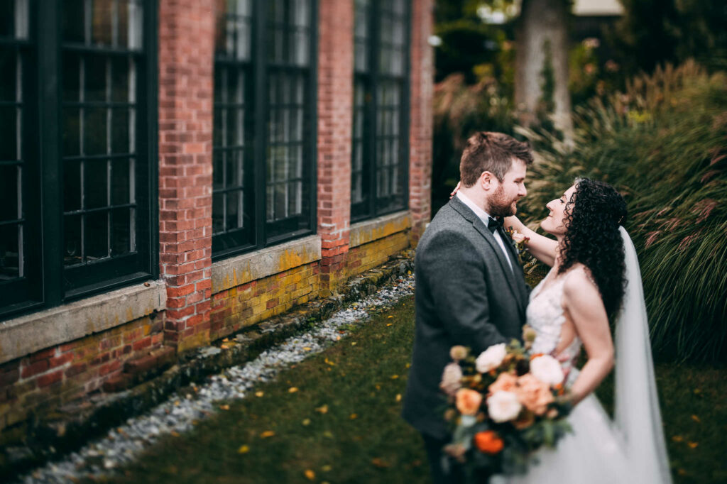 A bride and groom embrace during their wedding at The Lace Factory.