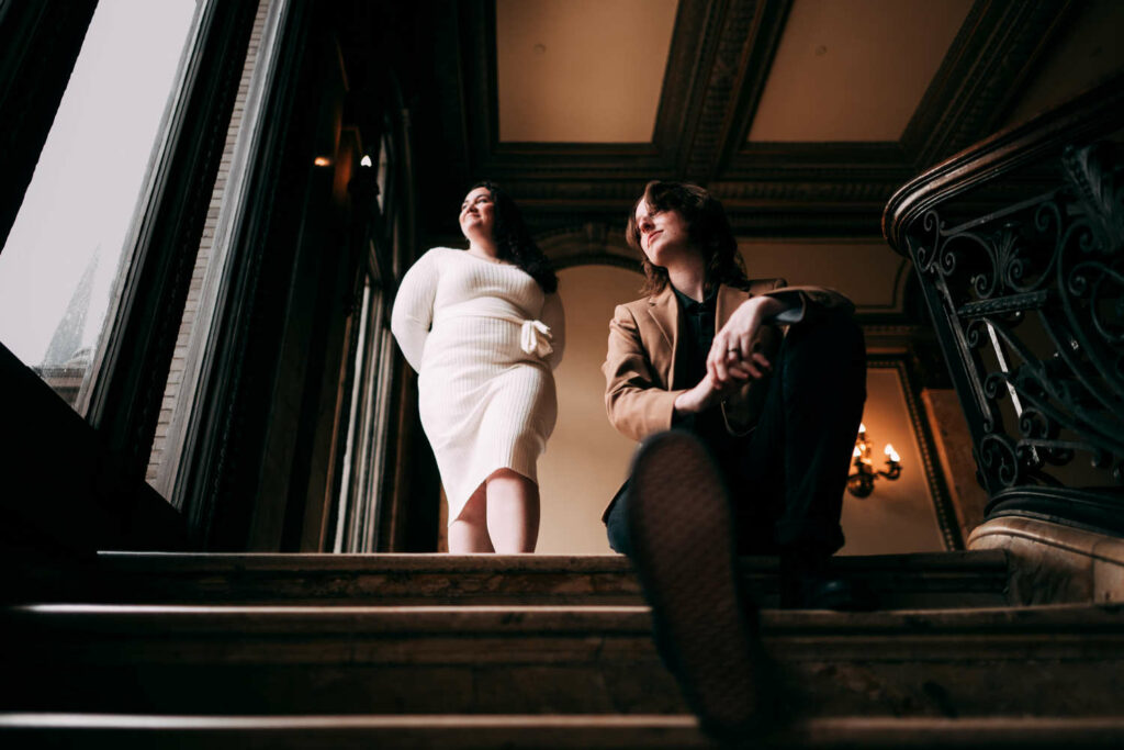 Two brides pose together during their Providence Public Library engagement session.