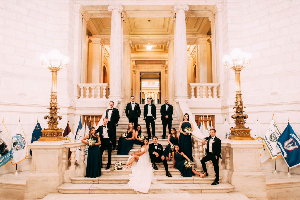 Rhode Island State house wedding party photo on a large white staircase.